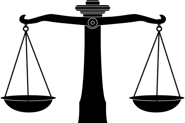 A black and white image of the scales of justice