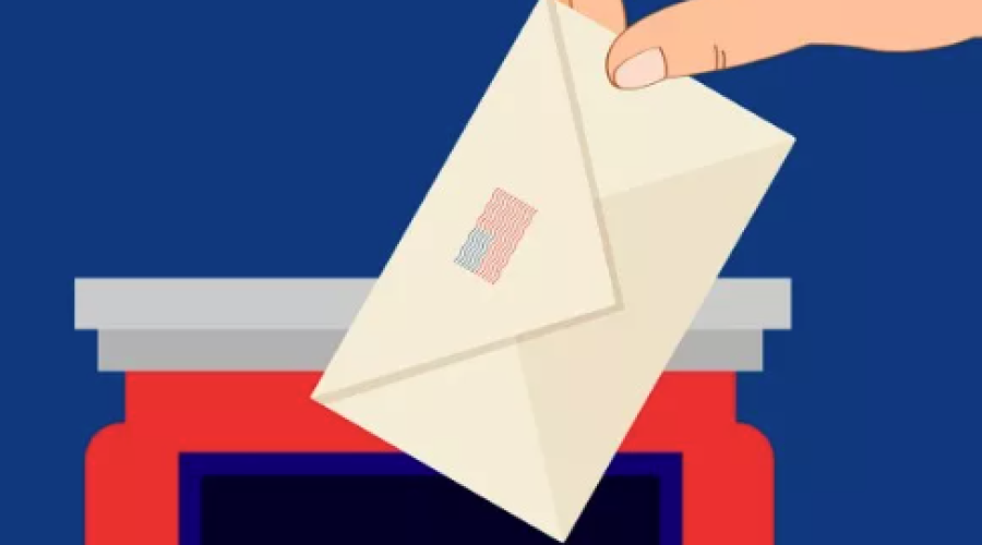 Red box with VOTE written in white, with hand dropping envelope into box