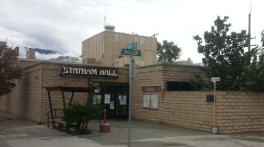 Beige and brown building with sign that says Statham Hall